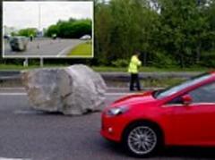 A real rocky road! Giant boulder causes hold-up on dual carriageway after falling off the back of a lorry