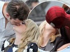 andrew garfield recreates on-screen smooch as he gives emma stone a lingering kiss at charity event