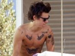 Harry Styles reveals the full extent of his tattoo obsession as goes shirtless in Barcelona
